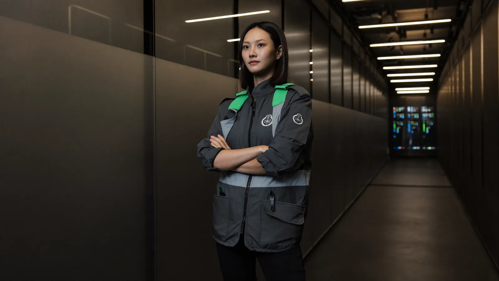 Security analyst standing in a server corridor